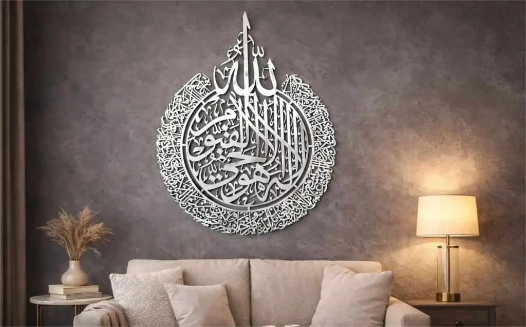 Large YOBESHO shiny silver metal Arabic calligraphy decor on a grey textured wall in a luxury living room.