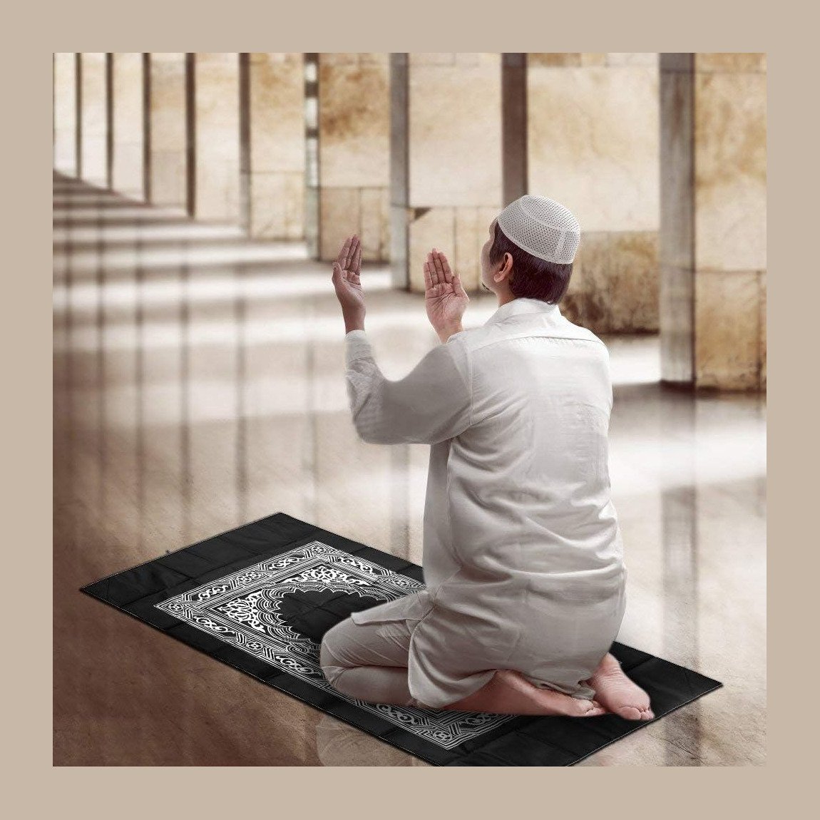 Muslim man praying on a black travel prayer mat with compass